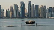 A boat makes its way past the Doha skyline in Doha, Qatar on Sunday, Jan. 18, 2026.