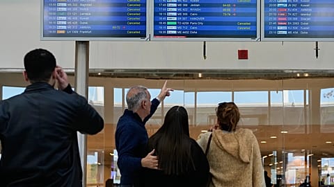 Travelers check departure times as many flights are cancelled at Beirut Rafik Hariri International Airport in Beirut, Lebanon, Saturday, Feb. 28, 2026,