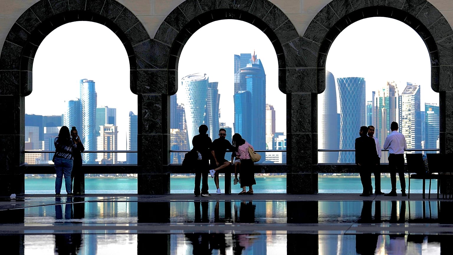 People snap pictures of the Doha skyline as they visit the Islamic Art Museum in Doha, Qatar on Sunday, Jan. 18, 2026.