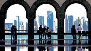 People snap pictures of the Doha skyline as they visit the Islamic Art Museum in Doha, Qatar on Sunday, Jan. 18, 2026.