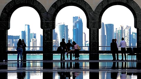 People snap pictures of the Doha skyline as they visit the Islamic Art Museum in Doha, Qatar on Sunday, Jan. 18, 2026.