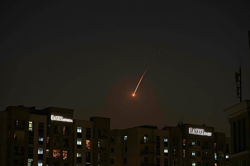 The flare of a projectile is seen over the skyline of Dubai, United Arab Emirates, Saturday, Feb. 28, 2026.