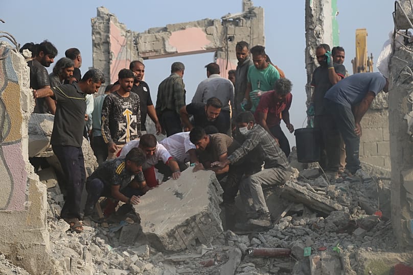 Rescue workers and residents search through the rubble in the aftermath of what Iranian officials said was an Israeli-U.S. strike on a girls' elementary school in Minab, Iran