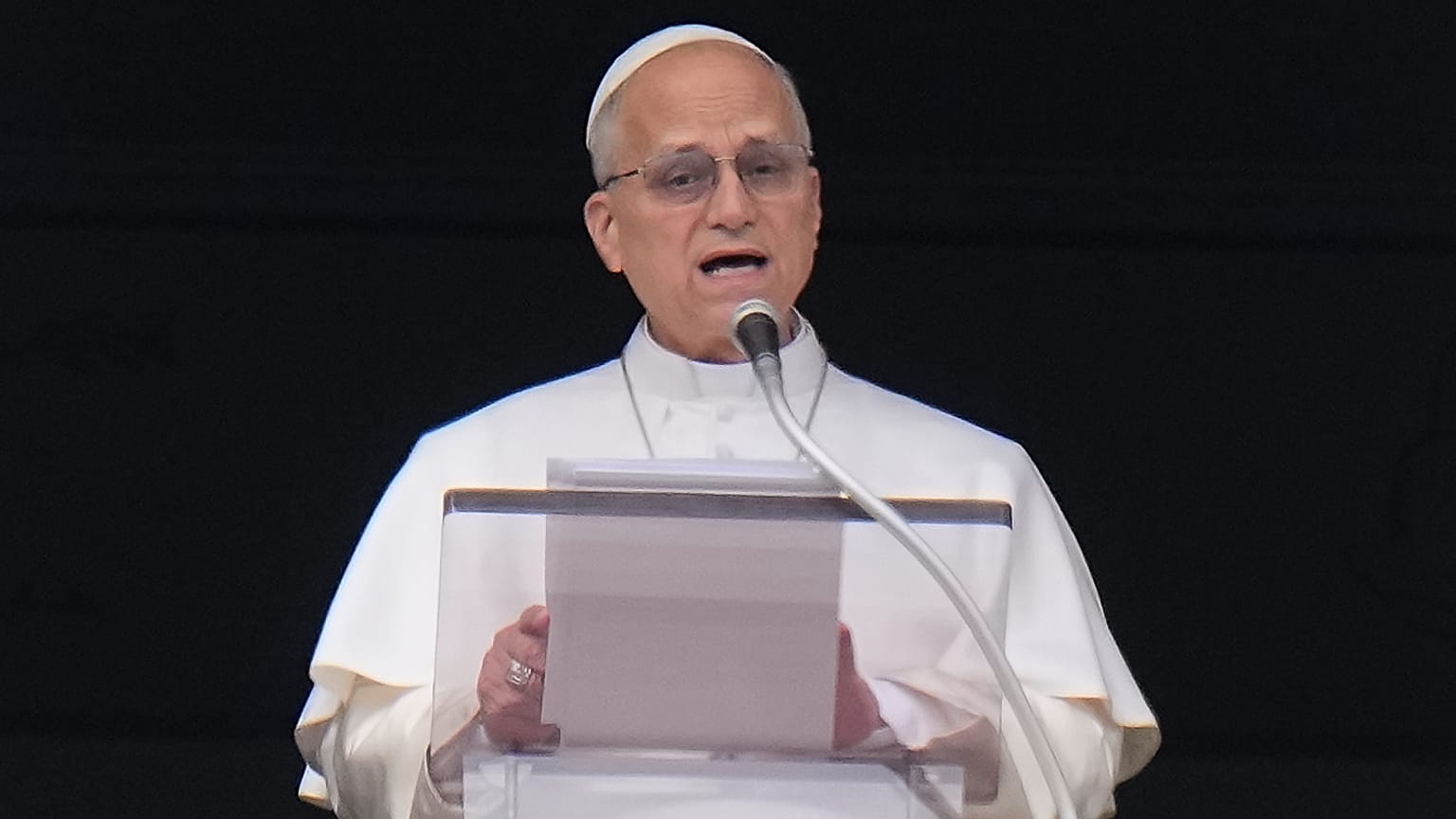 Pope Leo XIV appears at his studio's window overlooking St. Peter's Square at the Vatican for the traditional Sunday blessing of the faithful gathered for the noon Angelus pra