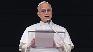 Pope Leo XIV appears at his studio's window overlooking St. Peter's Square at the Vatican for the traditional Sunday blessing of the faithful gathered for the noon Angelus pra