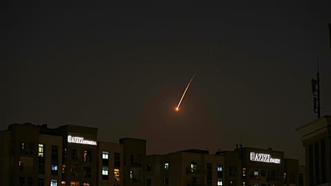 The flare of a projectile is seen over the skyline of Dubai, UAE on Saturday 28 February