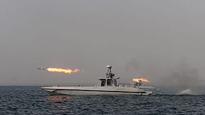 FILE. An Iranian navy boat fires a missile in a drill in the sea of Oman, on Dec. 2011.