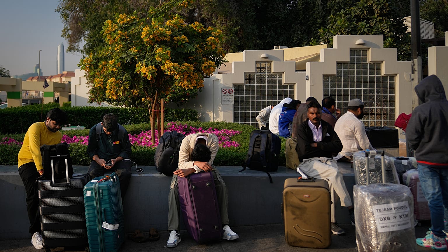 Passengers stranded by the closure of Dubai International Airport await for assistance in the airport parking lot in Dubai, United Arab Emirates, Sunday, March 1, 2026. (AP Ph