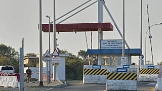 A British soldier stands guards at the main gate of the UK's RAF Akrotiri base after it was hit by a suspected drone strike early morning near Limassol, Cyprus, Monday.