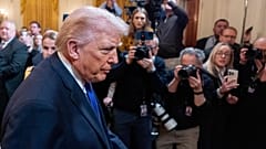 US President Donald Trump passes reporters in the East Room of the White House, 2 March, 2026