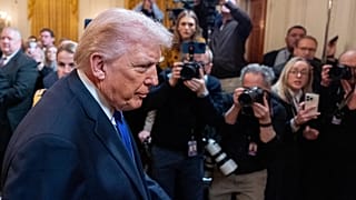 US President Donald Trump passes reporters in the East Room of the White House, 2 March, 2026