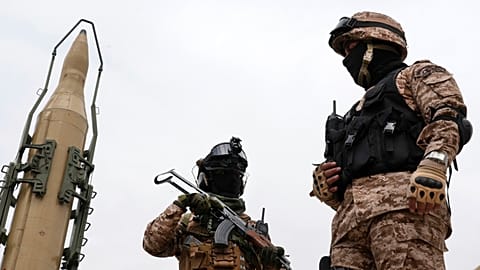 FILE: Iran's Revolutionary Guard members stand in front of Shahab-3 missile which is displayed during the annual rally in Tehran, 29 April 2022