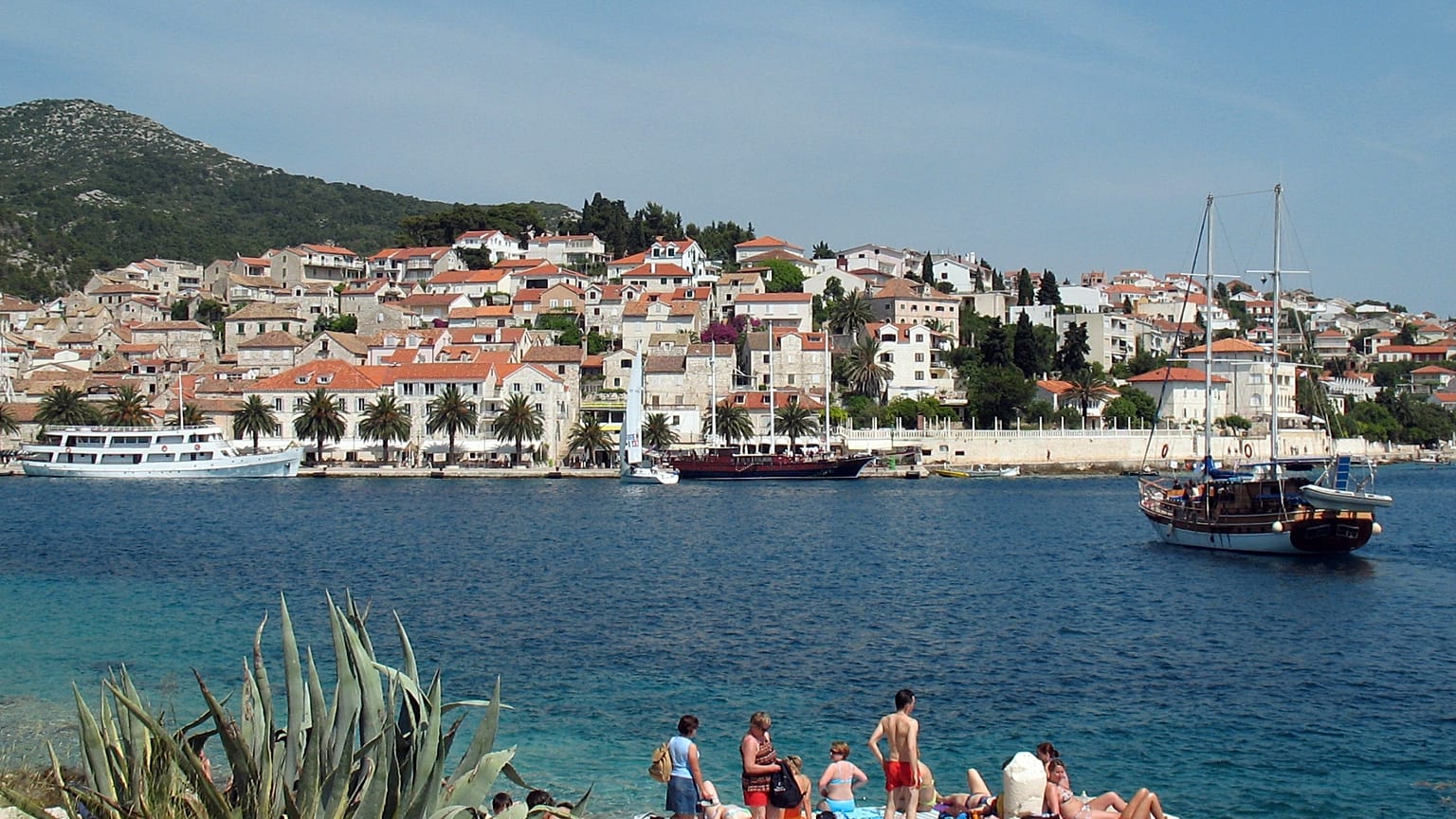 Several tourists sunbathe in the port of Hvar, Croatia, in this May 2007 photo taken in the Dalmatian islands.
