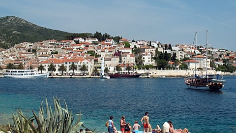 Several tourists sunbathe in the port of Hvar, Croatia, in this May 2007 photo taken in the Dalmatian islands.