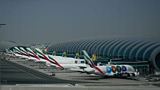 Emirates airplanes are parked at the Dubai International Airport after its closure 