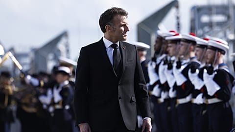 French President Emmanuel Macron reviews the troops during his visit to the nuclear submarine navy base of Ile Longue in Crozon, France