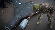 A Ukrainian officer shows a downed Shahed drone with its thermobaric charge launched by Russia in a research laboratory at an undisclosed location in Ukraine on 14 Nov. 2024.