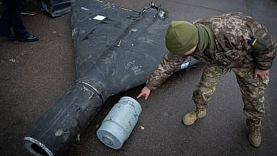 A Ukrainian officer shows a downed Shahed drone with its thermobaric charge launched by Russia in a research laboratory at an undisclosed location in Ukraine on 14 Nov. 2024.