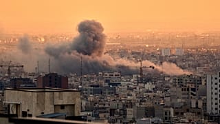 A plume of smoke rises following a US-Israeli military strike in Tehran, 3 March, 2026