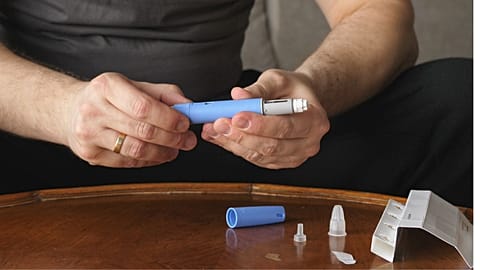 A person prepares a semaglutide jab.