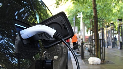 Close-up shot of an EV car being charged.
