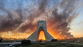 FILE: Smoke rises up behind Azadi or Freedom tower, following a US-Israeli military strike in Tehran, 3 March 2026