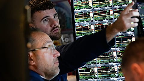 FILE. Traders work on the floor at the NYSE, New York, Nov. 2022