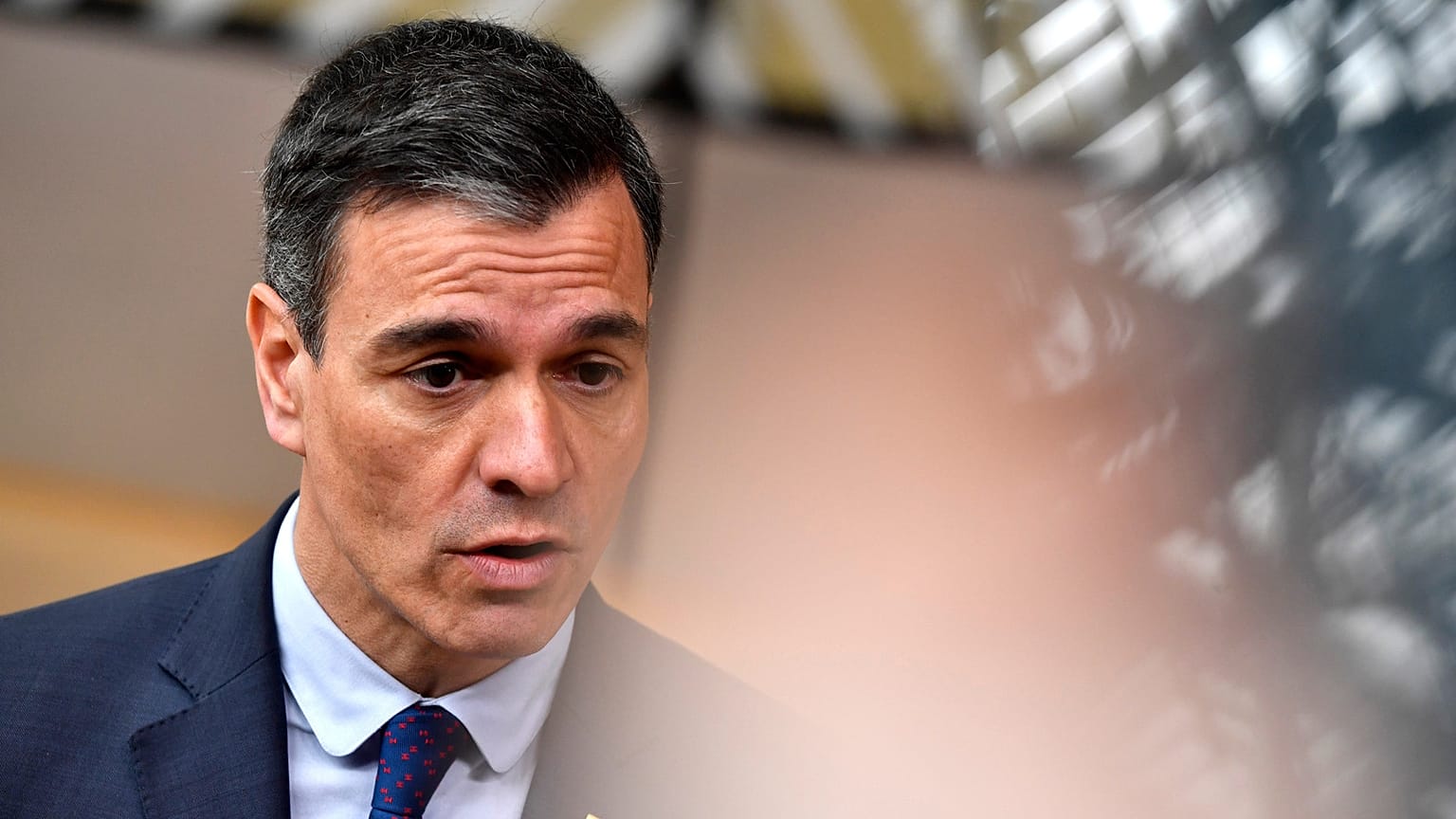 Spain's Prime Minister Pedro Sanchez speaks with the media as he arrives for an EU summit at the European Council building in Brussels, Thursday, March 23, 2023
