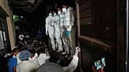 Healthcare workers unload the bodies of Iranian sailors from a vehicle who died when their IRIS Dena warship sank outside Sri Lanka's territorial waters, in Galle, Sri Lanka.
