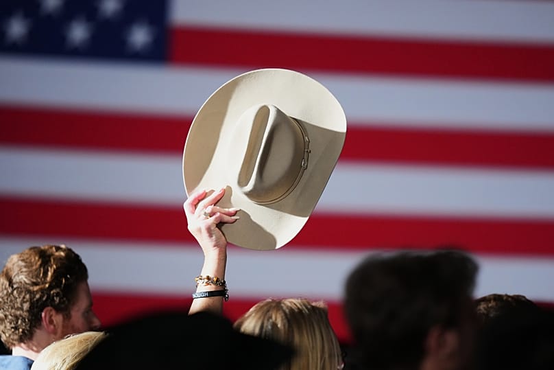 A supporter raises their hat at an election night primary watch party for Texas Attorney General Ken Paxton, March 3, 2026.