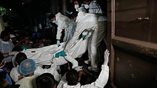 Healthcare workers unload from a vehicle the bodies of Iranian sailors who died when their IRIS Dena warship sank outside Sri Lanka's territorial waters, in Galle, Sri Lanka