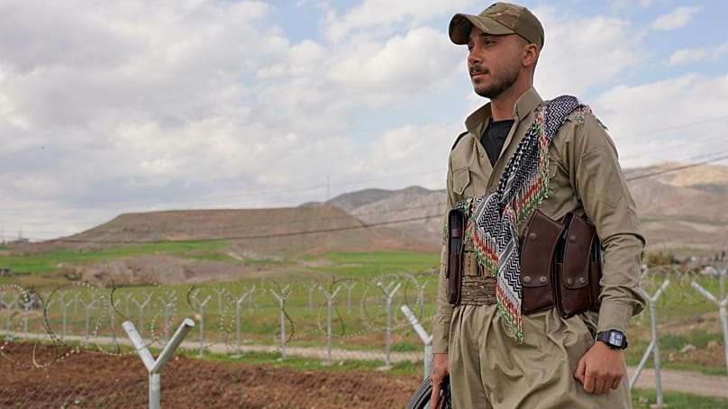 Member of the Democratic Party of Iranian Kurdistan PDKI stands at a checkpoint leading to their base in Koya district of Irbil, Iraq, Friday, Feb. 27, 2026