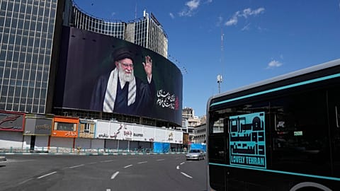 Tehran, Iran: Vehicles drive past a billboard showing a portrait of the late Iranian Supreme Leader Ayatollah Ali Khamenei, who was killed in a military operation.