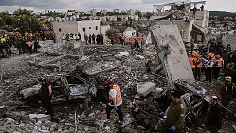 Rescue workers and military personnel operate at the scene where several people were killed in an Iranian missile strike in Beit Shemesh, Israel, Sunday, March 1, 2026. 