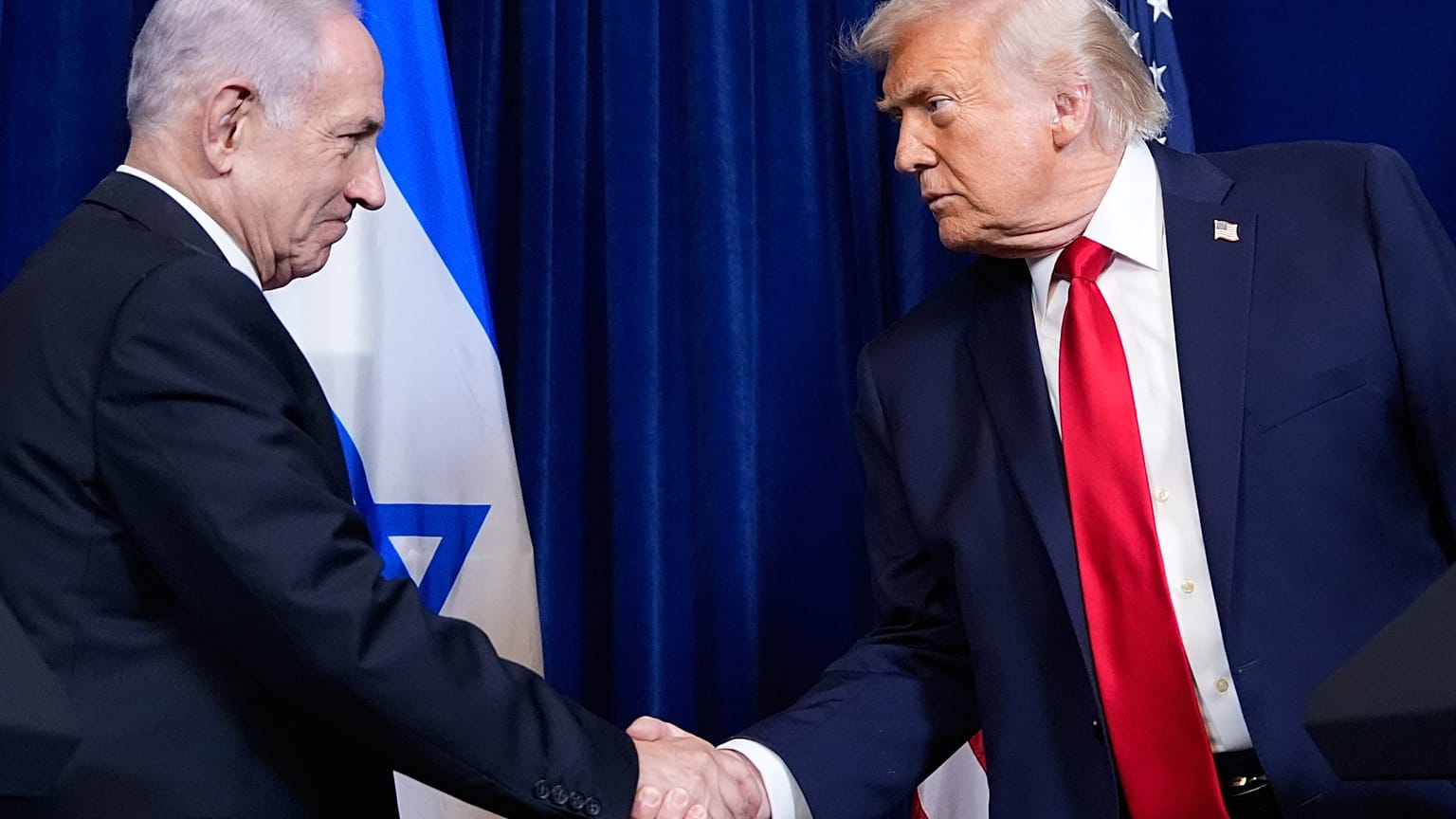 President Donald Trump shakes hands with Israel's Prime Minister Benjamin Netanyahu during a news conference at Mar-a-Lago, Dec. 29, 2025, in Palm Beach, Fla.