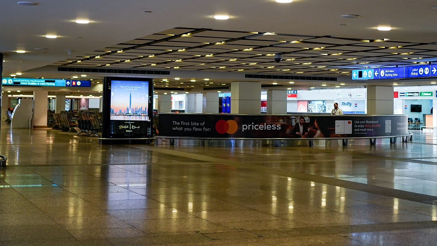 A worker is seen in the empty arrival hall at the Dubai International Airport terminal as the airport resumes limited operations in Dubai, United Arab Emirates, 5, 2026