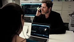 John Brownstein, right, co-founder of HealthMap, a system using artificial intelligence to monitor global disease outbreaks, speaks on a phone in a HealthMap work area at Bost