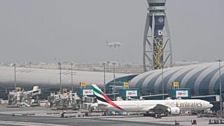 An Emirates Boeing 777 stands at the gate at Dubai International Airport, 17 August, 2022