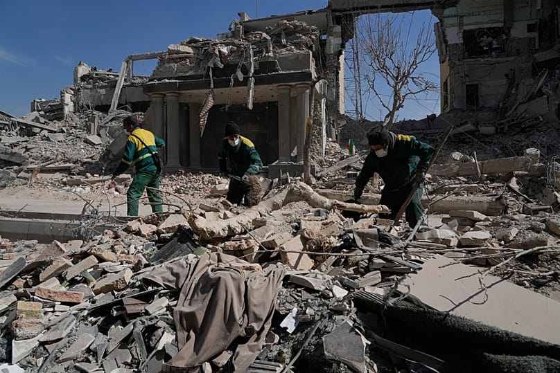 Workers remove rubble at a police station in Tehran, 4 March, 2026