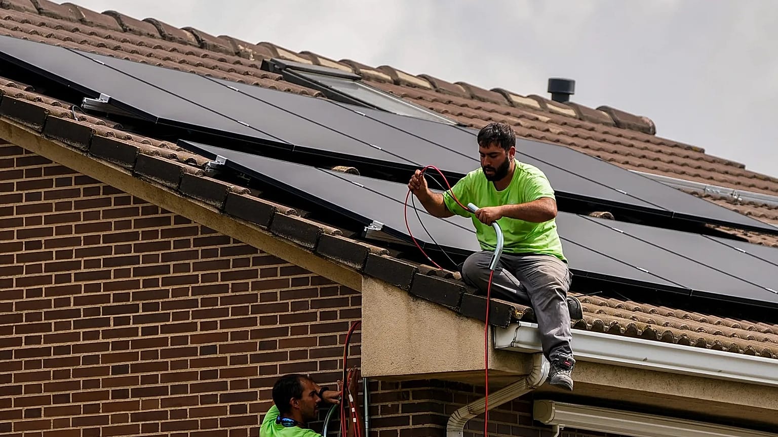 Workers install solar planers on the roof of a house in Rivas Vaciamadrid, Spain.