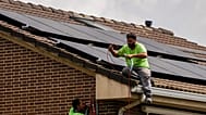 Workers install solar planers on the roof of a house in Rivas Vaciamadrid, Spain.
