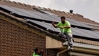 Workers install solar planers on the roof of a house in Rivas Vaciamadrid, Spain.
