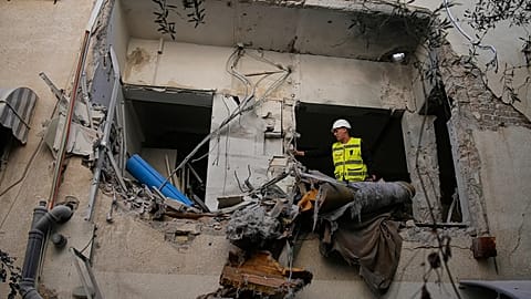 Israeli security forces inspect a damaged apartment building struck by an Iranian missile in Tel Aviv, 8 March, 2026
