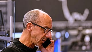 A broker makes a phone call at the stock exchange in Frankfurt, Germany. 23 May 2025. 