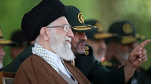 FILE: Ayatollah Ali Khamenei listens to the then commander of the Revolutionary Guard Mohammad Ali Jafari during a graduation ceremony in Tehran, 20 May 2015