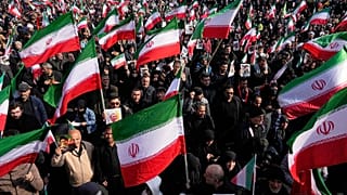 A crowd holding Iranian flags gathers during a demonstration in Tehran, 9 March, 2026