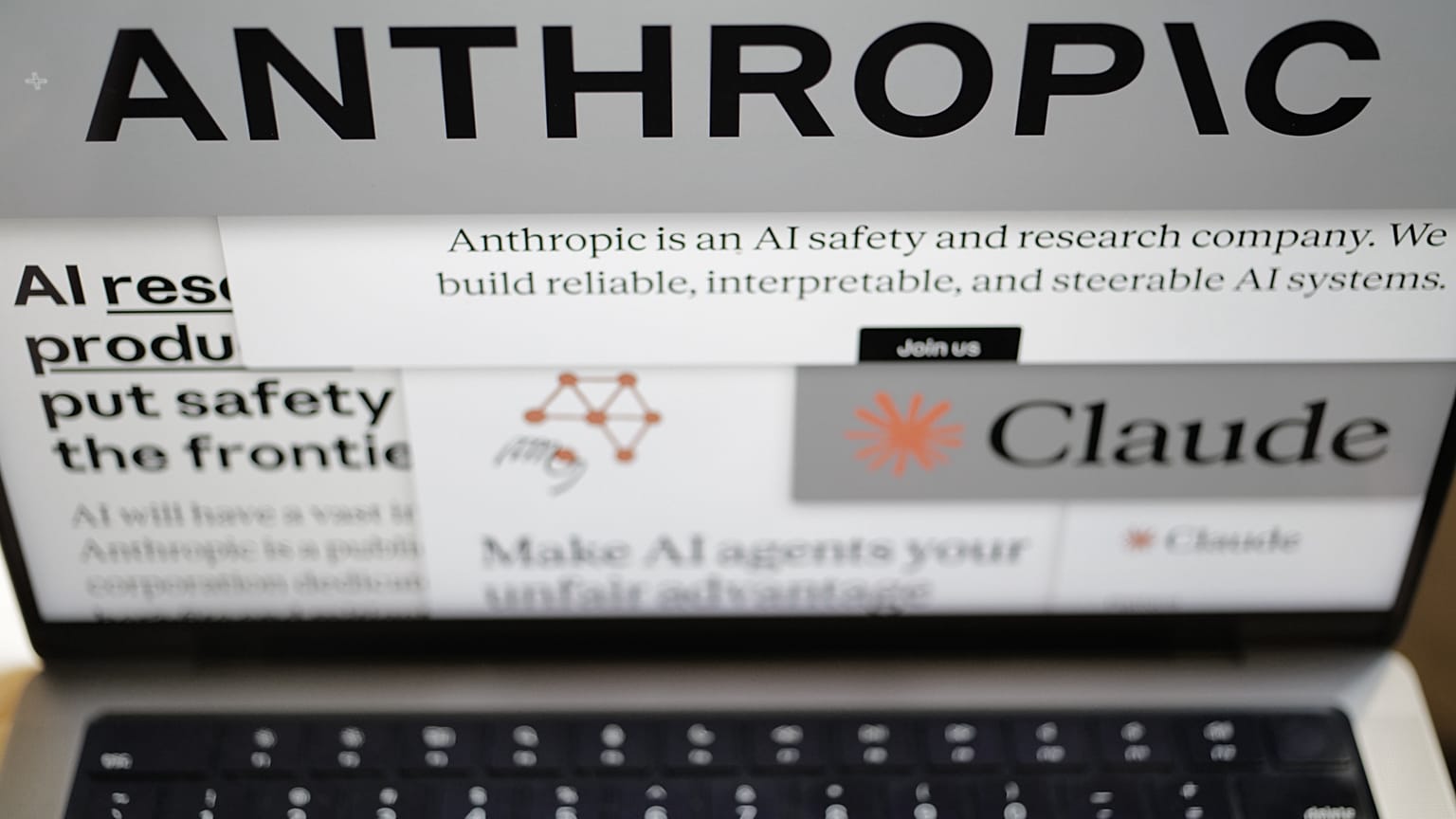 Pages from the Anthropic website and the company's logos are displayed on a computer screen in New York on Thursday, Feb. 26, 2026.