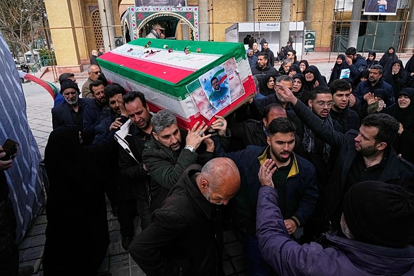 The coffin of Mehdi Hosseini, a man killed in a U.S.-Israeli strike, is carried for burial at Behesht-e Zahra cemetery in Tehran, Iran, Monday, March 9, 2026