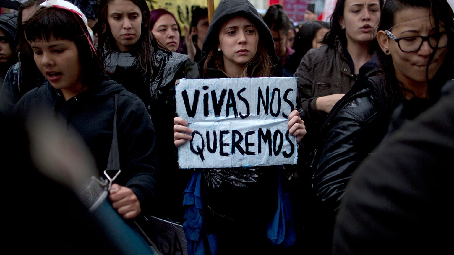 A woman carries a banner that reads in Spanish "We want us alive" during a demonstrating against gender violence in Buenos Aires, Argentina, Wednesday, Oct. 19, 2016