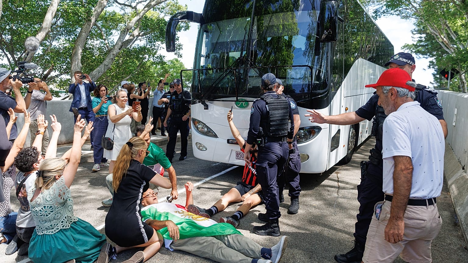 Protesters block the progress of a bus believed to be carrying the Iranian women's soccer team as it attempts to leave a hotel on the Gold Coast, Australia,